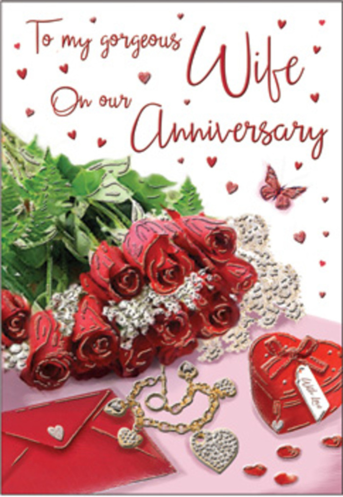 In this richly detailed anniversary card image, a bouquet of classic red roses commands attention, each bloom luxuriously full, with layered petals that curve outward like tiny velvet sculptures. The flowers are elegantly wrapped and supported by lush green foliage, the leaves providing a fresh, natural contrast that suggests they've just been arranged by an expert florist familiar with Stoke Newington's romantic side streets. The deep reds and vivid greens form the visual core, while around them, a collection of intimate keepsakes tells a quiet story of love over time. A vivid red box-its surface smooth, perhaps satin-finished-rests nearby, hinting at a hidden gift, maybe a ring or earrings saved for an anniversary surprise. A jewellery set glints softly, gold or silver tones catching the light, its delicate shapes echoing the theme of devotion. Whisper-thin lace peeks into the frame, adding a layer of gentle texture, almost like the trim of a cherished dress or the edge of a wedding veil. Tiny heart motifs dot the scene, some printed, some perhaps shaped from shimmering foil, offering little sparks of light that enliven the composition. The card's scripted message curves gracefully across the design, the handwriting-style font reinforcing the feeling of something personally written and from the heart. The atmosphere is warm and enveloping, like a quiet evening spent in a Stoke Newington townhouse, with every detail-from the suggestion of velvet and silk to the luxurious depth of the roses-evoking long-lasting affection and the joy of marking another anniversary together.